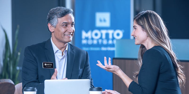 Woman and man talking about new franchise and their Motto Mortgage office